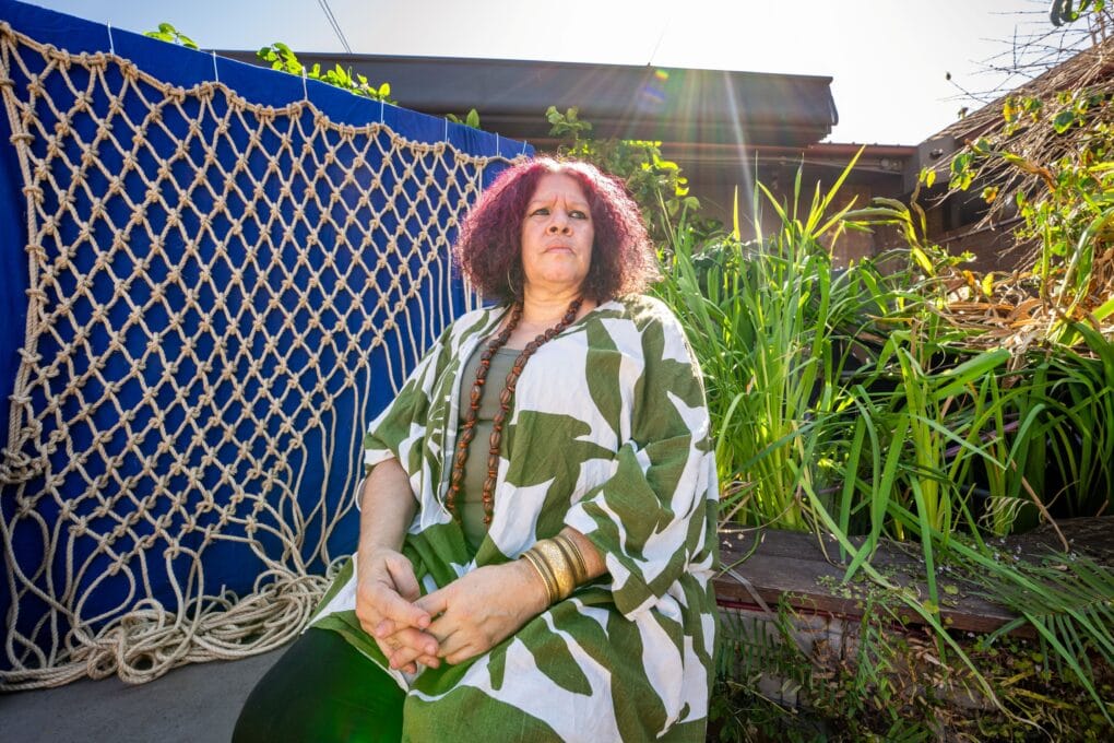 Nadeena Dixon with the net used for the Birrang Narrami artwork for the Sydney Fish Market