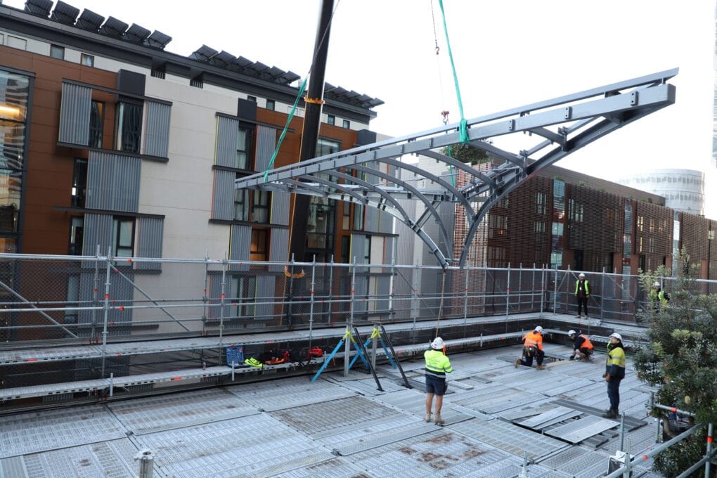 Craning in one of the pieces of the canopy to the third floor terrace.
